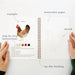 Open notebook with a chicken illustration, labeled 'example', 'watercolor paper', 'step-by-step instructions', 'lay-flat binding'.