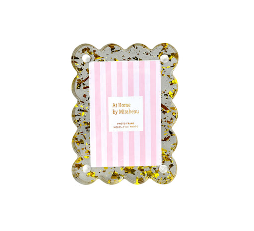 Decorative photo frame with gold glitter accents on a white background