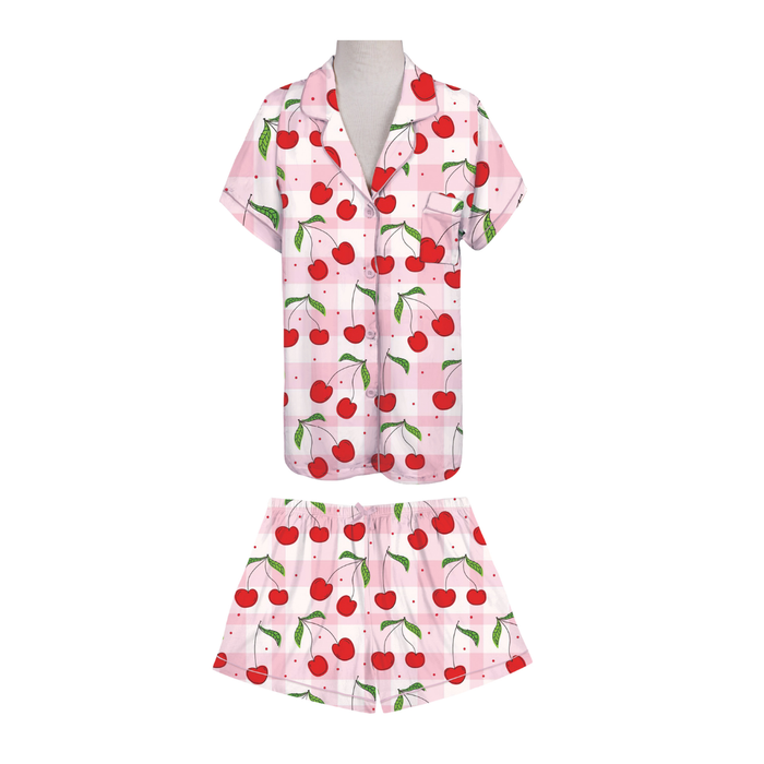 Pink pajama set with cherry pattern on a white background