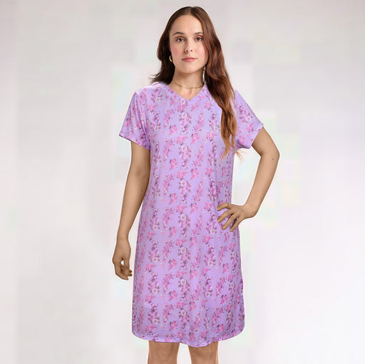 Woman wearing a purple floral dress against a white background