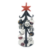 A black metal Christmas tree stand with a red star topper and several hanging ornaments, including black, white, and clear glass baubles with red glitter, set against a plain white background.