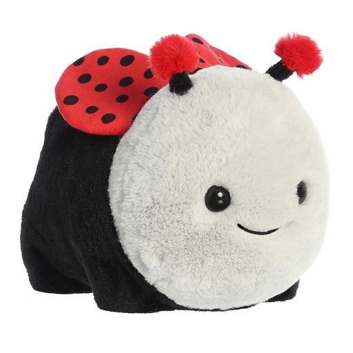 Plush toy shaped like a ladybug with red wings and black spots on a white background