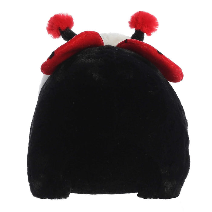 Black plush toy with red pom-pom ears on a white background