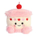 Plush toy shaped like a cupcake with pink frosting, red cherry, and heart decorations on a white background.