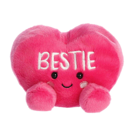 Pink plush heart with 'BESTIE' text on a white background