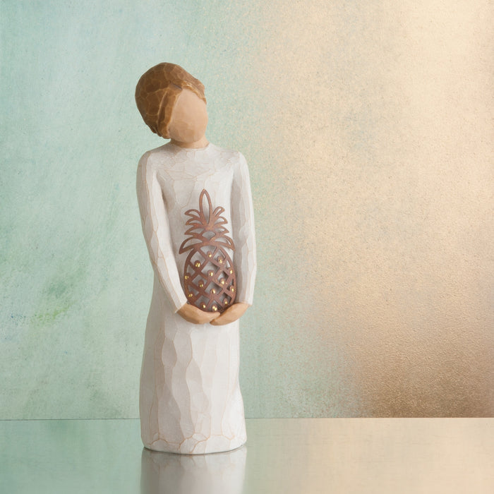 Decorative figurine holding a pineapple-shaped lantern against a gradient background