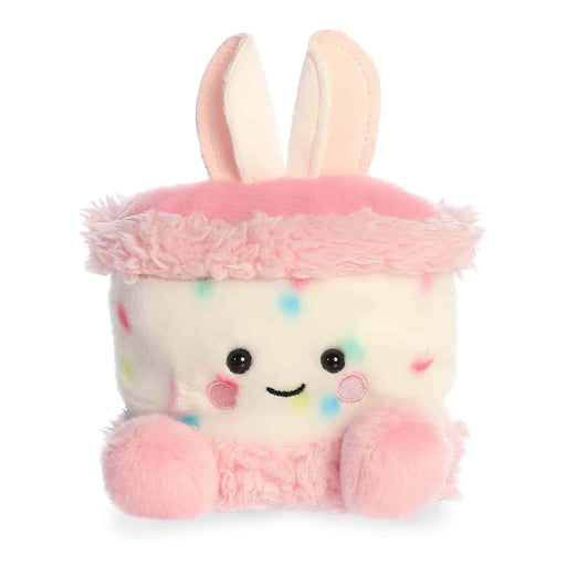 Plush toy with a pink bunny hat on a white background