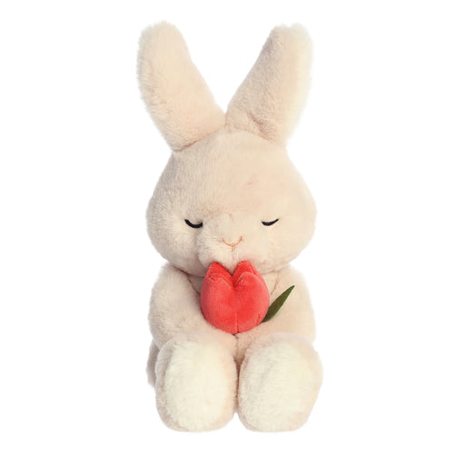 Plush rabbit toy holding a red heart on a white background