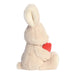 Plush bunny holding a red heart on a white background