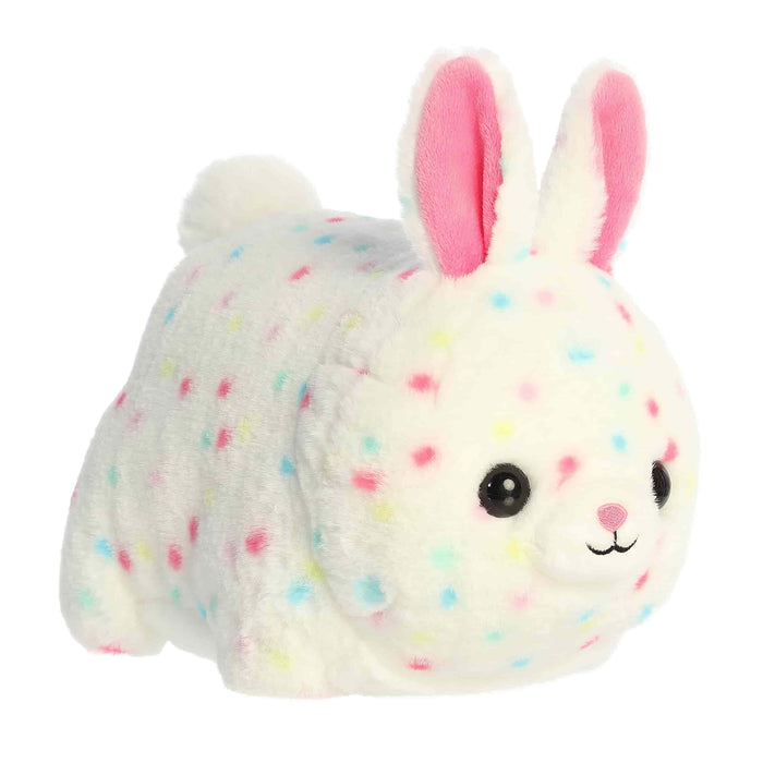 Plush toy rabbit with colorful spots on a white background