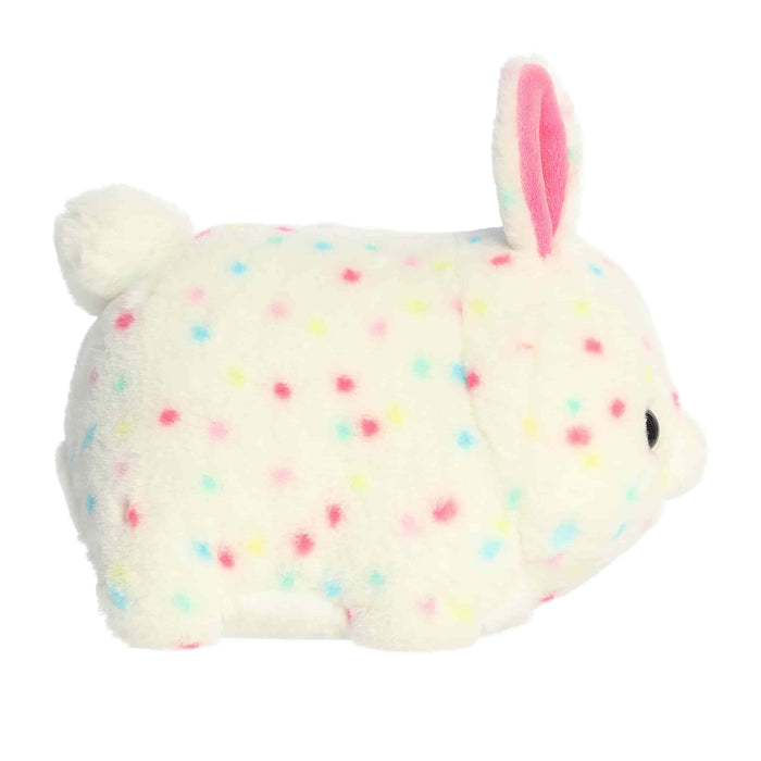 Plush toy rabbit with colorful polka dots on a white background