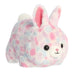 Plush toy rabbit with tie-dye pattern on a white background
