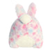 Plush toy with bunny ears in pastel tie-dye pattern on a white background