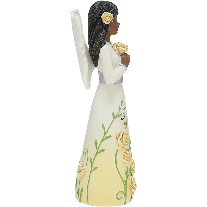 Figurine of a woman holding flowers with floral design on a white background