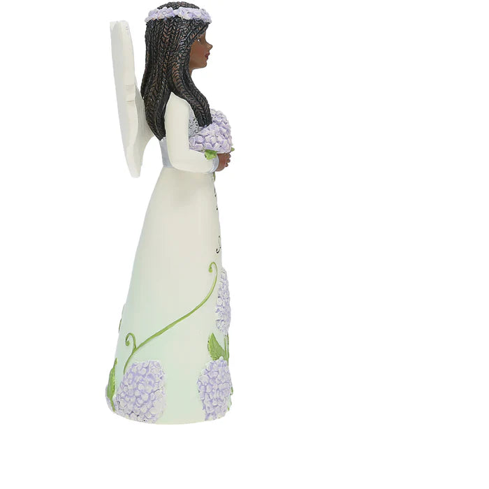 Angel figurine with floral design on a white background