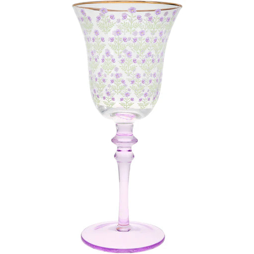 Decorative wine glass with floral pattern and pink stem on a white background