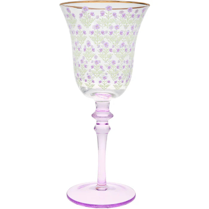 Decorative wine glass with floral pattern and pink stem on a white background
