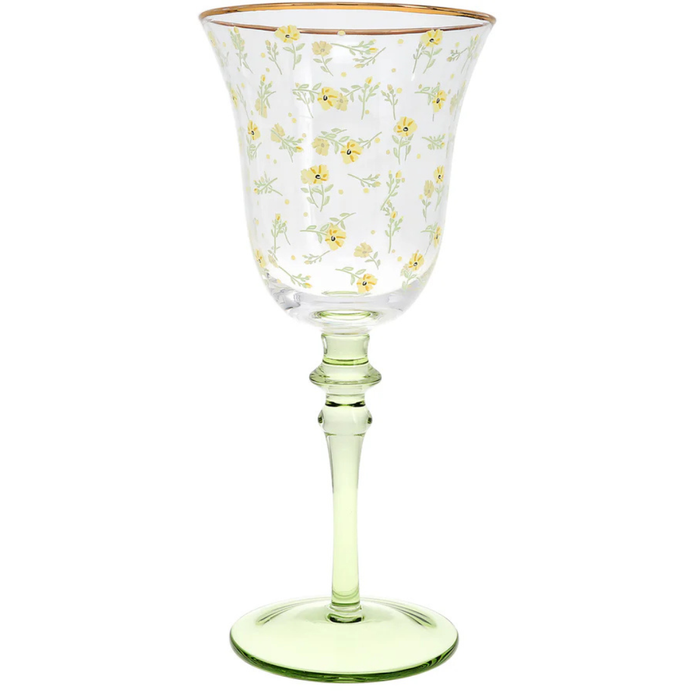 Clear glass with yellow floral pattern and gold rim on a white background