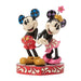 Two cartoon characters on a decorative base with a white background