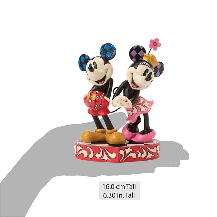 Figurine of two cartoon characters on a decorative base with height measurement text.