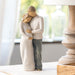 Statue of a couple embracing on a table with a blurred background
