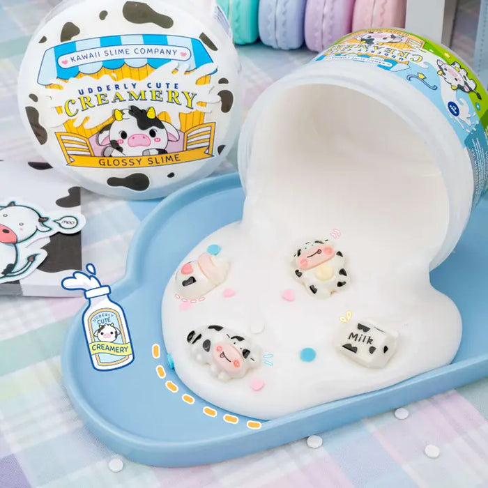 Kawaii slime product with cow-themed packaging and characters on a checkered background.
