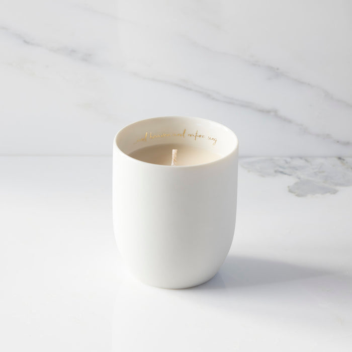 White ceramic mug with gold text on a marble surface