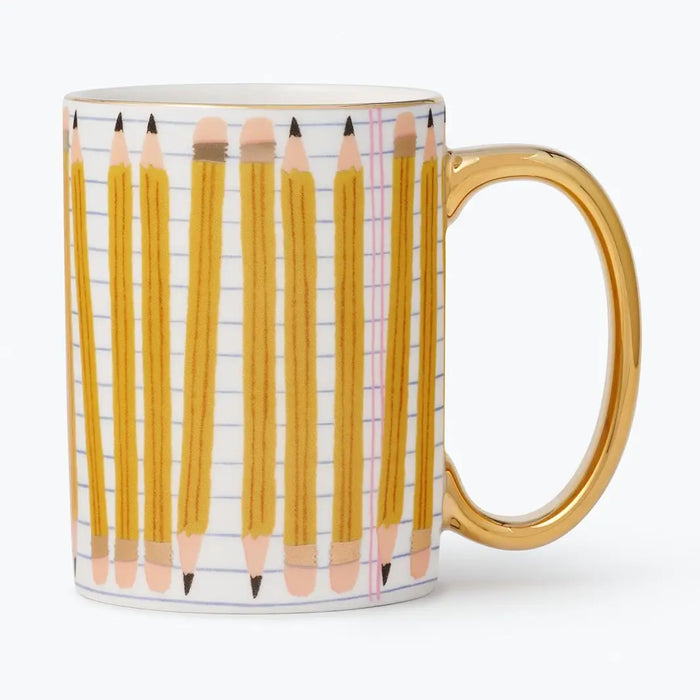 A white ceramic mug featuring a printed pattern of yellow pencils on lined notebook paper, with a shiny gold handle and rim.