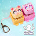 Two cute cartoon mouse-shaped clickers in pastel colors, one yellow with pink accents and one pink with purple accents, both sitting in matching plastic bases with a metal key ring attached, on a light blue background with a 'Mystery Clickzee 2' graphic overlay.