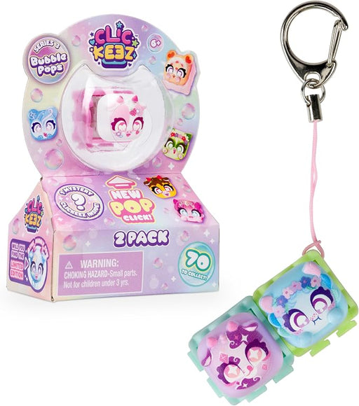 A 2-pack display box of Clic Kesz 'Fuzzy Bubble Pops' toy figures alongside two individual pop-up bubble pop toys attached to keychains, shown on a white background.
