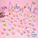 A collection of small colorful toy figurines displayed on pink pedestals and across a pink surface, with a hand placing one figurine on the left. A round badge in the bottom right reads '70 to collect!'.