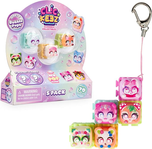 A 5-pack of Clie Kezz Clickable Collectibles Bubble Pops toy set, showing the retail packaging box and four individual translucent pop-up bubble characters with colorful cartoon faces, alongside a silver carabiner clip on a white background.
