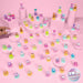 A collection of small colorful toy figurines displayed on pink pedestals and across a pink surface, with a hand placing one figurine on the left. A round badge in the bottom right reads '70 to collect!'.