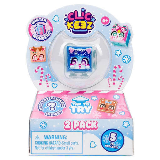 Clic Kizz 2 Pack of winter-themed toy clickers in retail packaging, featuring a blue penguin clicker in a clear dome and a pink and blue box with a warning label and '5 to collect' badge.