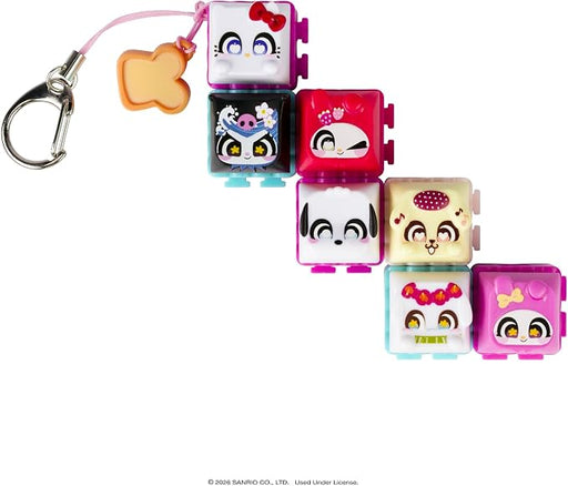 A set of six small square character keychain charms with a silver carabiner and pink string, arranged diagonally on a white background. The characters include Hello Kitty, an anime character in a black outfit, a pink cat character, a black-and-white dog character, a cream-colored character with a red polka-dot headpiece, and a pink character with a yellow bow.