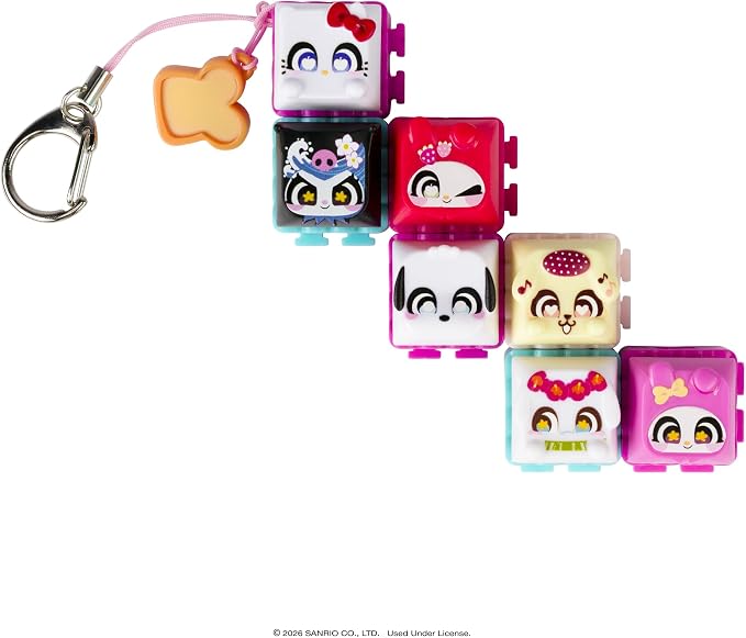 A set of six small square character keychain charms with a silver carabiner and pink string, arranged diagonally on a white background. The characters include Hello Kitty, an anime character in a black outfit, a pink cat character, a black-and-white dog character, a cream-colored character with a red polka-dot headpiece, and a pink character with a yellow bow.