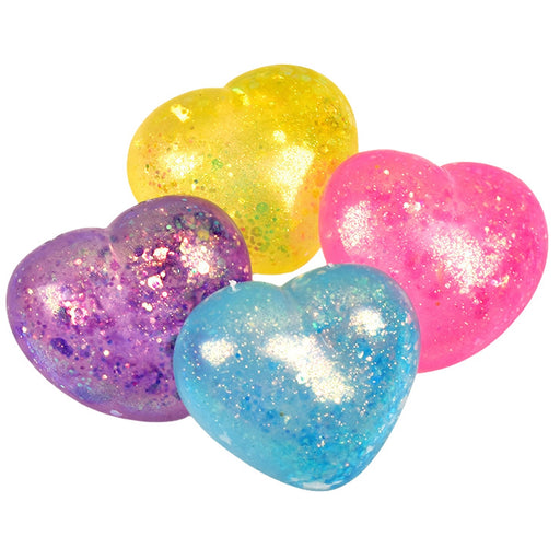 Colorful glittery heart-shaped objects on a white background