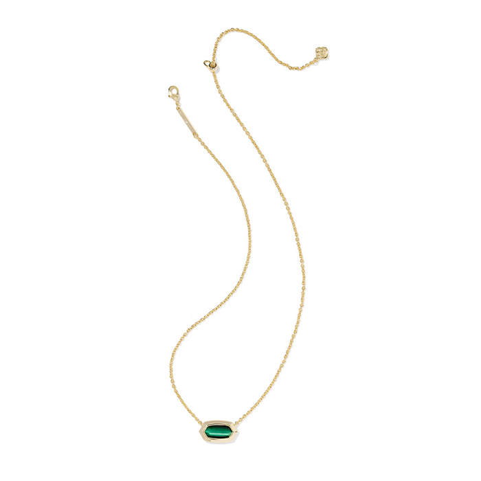 Gold necklace with a green gemstone on a white background