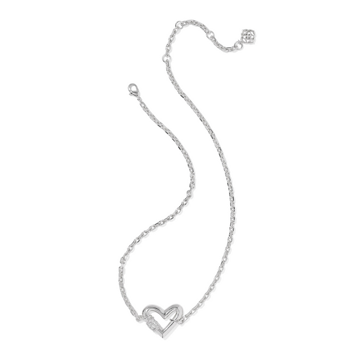 Silver heart-shaped pendant on a chain against a white background