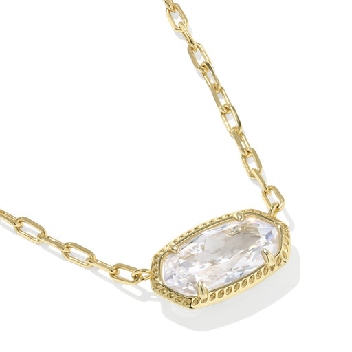 Gold necklace with a clear gemstone pendant on a white background