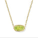 Gold necklace with a green gemstone pendant on a white background