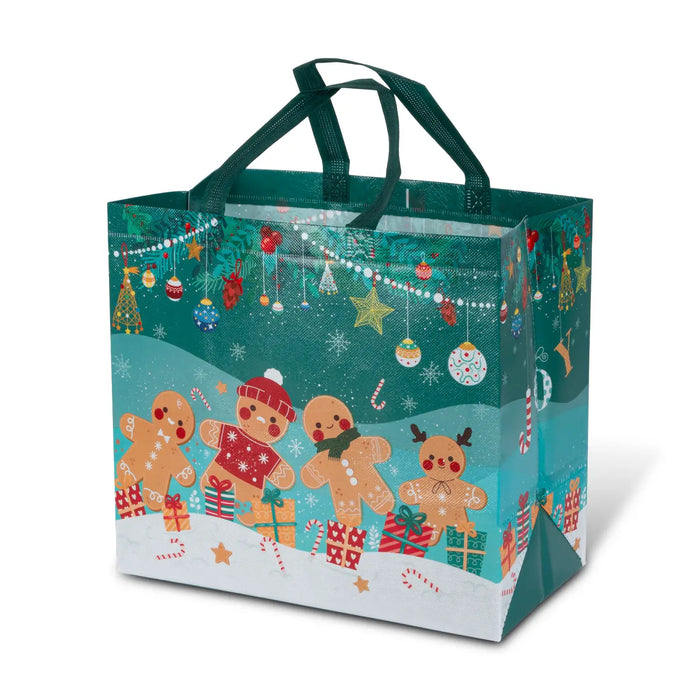 A festive Christmas gift bag with dark green handles, featuring a printed design of three gingerbread cookies, candy canes, ornaments, and snowflakes on a teal and white background.