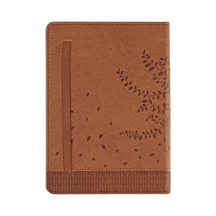 Brown leather notebook with embossed design on a white background