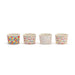 Four small ceramic cups with colorful patterns on a white background