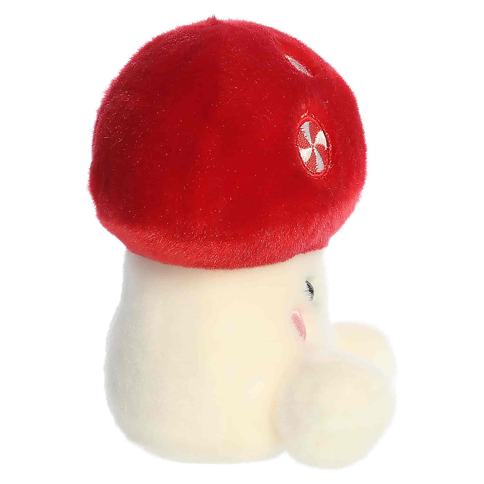 Plush toy with a red cap and white face on a white background