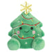 Plush toy shaped like a Christmas tree with a smiling face on a white background
