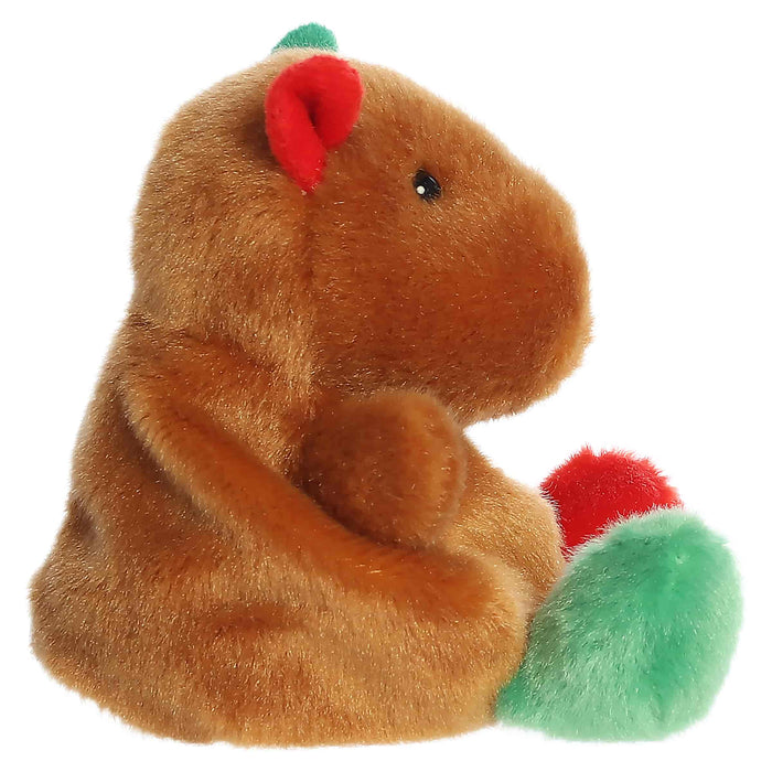 Plush toy resembling a brown animal with red and green accents on a white background