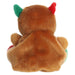 Back view of a plush toy with brown fur, green and red accents on a white background