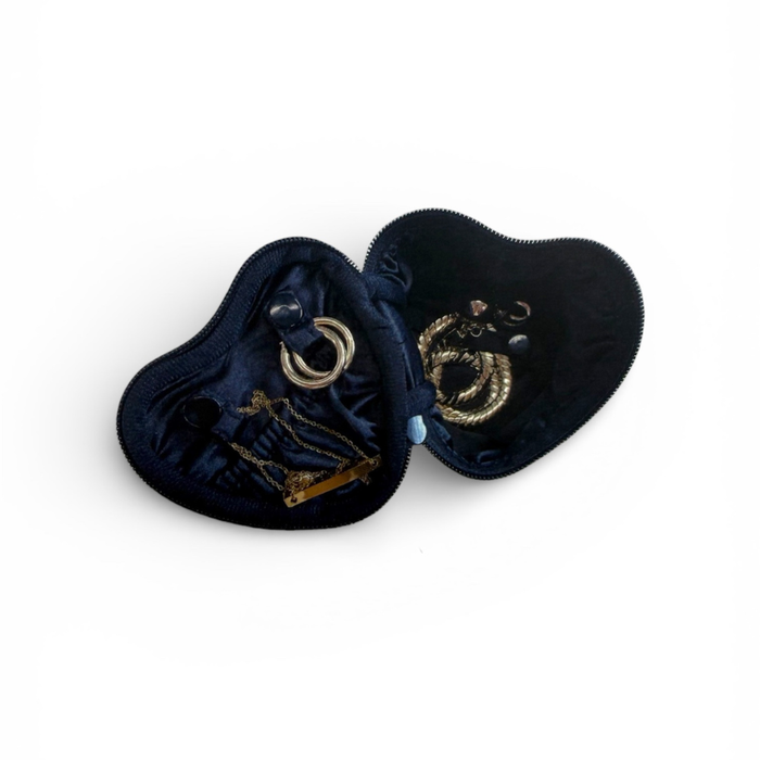Navy blue heart-shaped jewelry pouch with embroidered designs on a white background