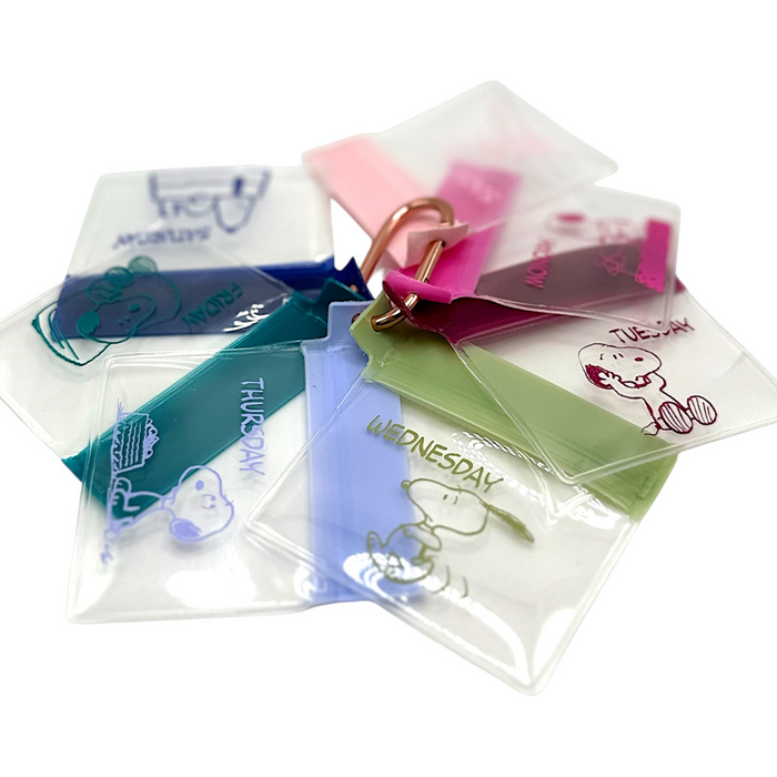 Set of clear plastic bags with days of the week labels and cartoon characters on a white background